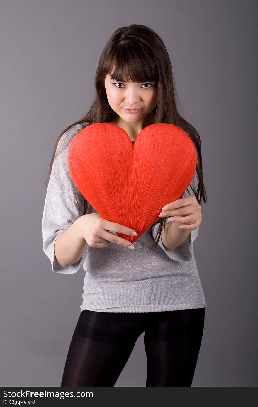 Beautiful woman holding red heart