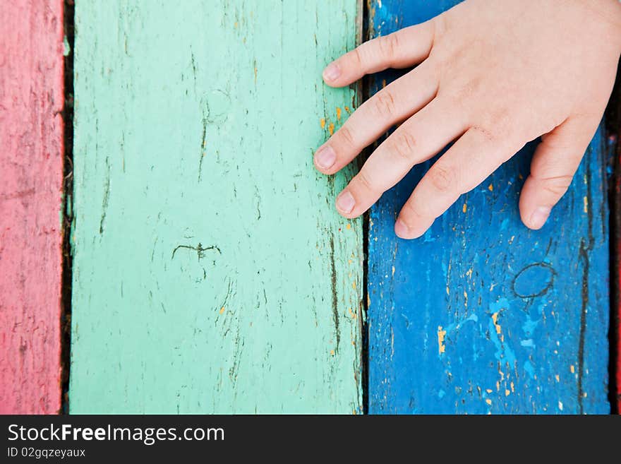 Color wooden boards with child hand