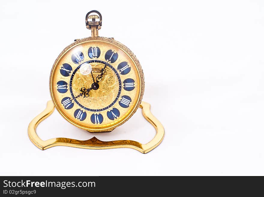 Antique gold clock isolated on a white background. Antique gold clock isolated on a white background