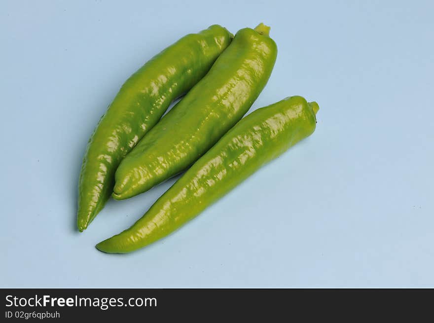 Light blue background of green pepper