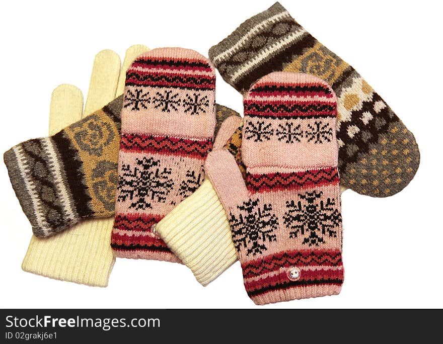 Different knitted gloves  isolated on white