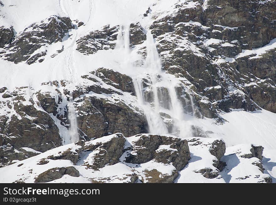 Small avalanche on Mount Cervino in a sunny day.