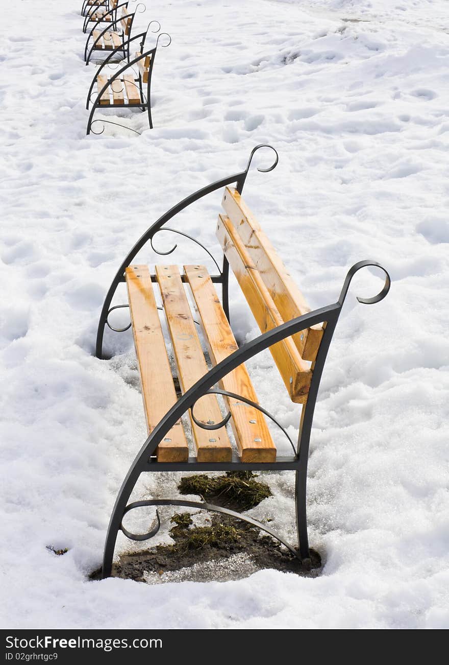 Light Brown Wooden Benches On Snow