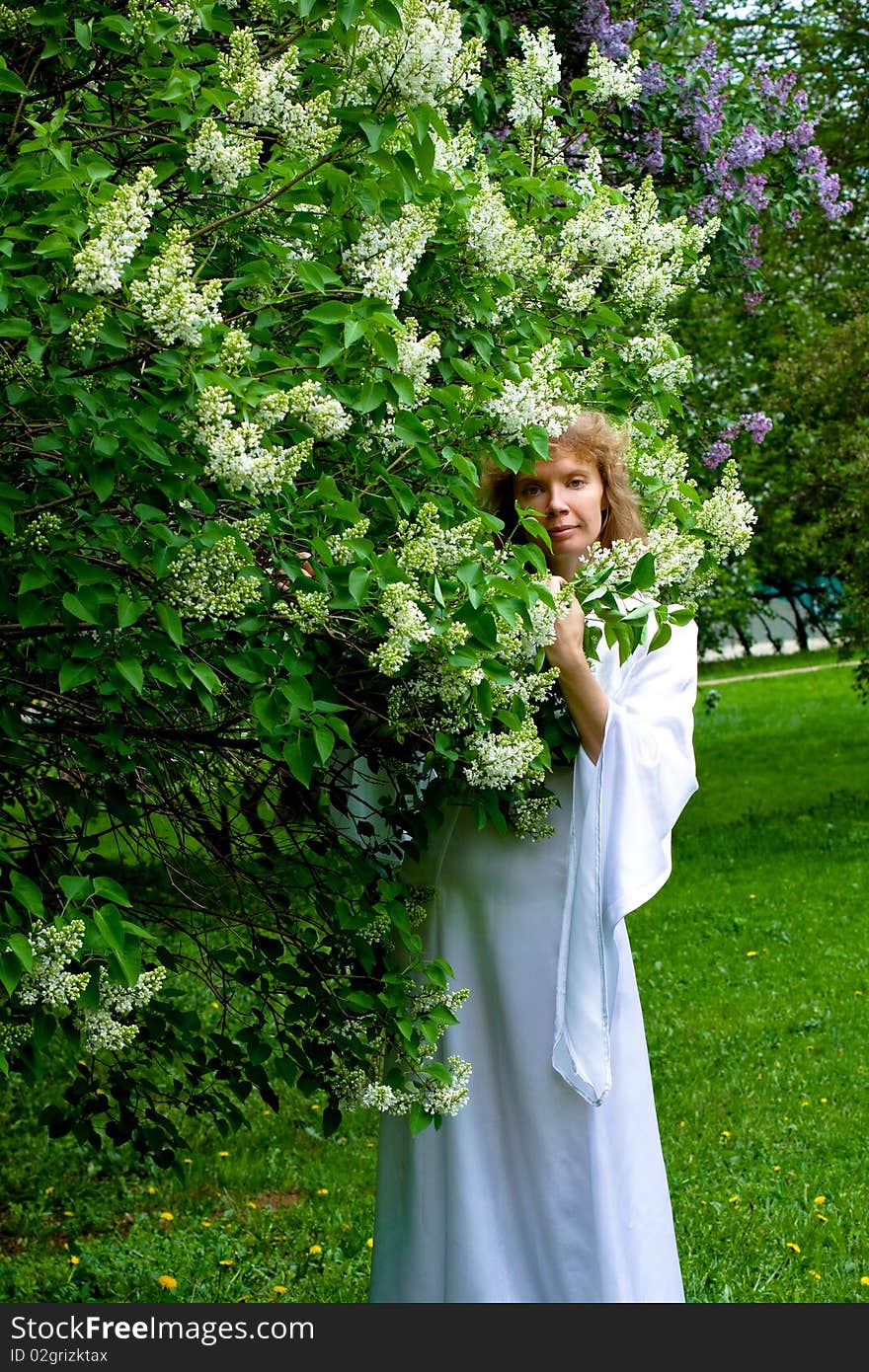 The blonde girl in white dress and white flowers. The blonde girl in white dress and white flowers