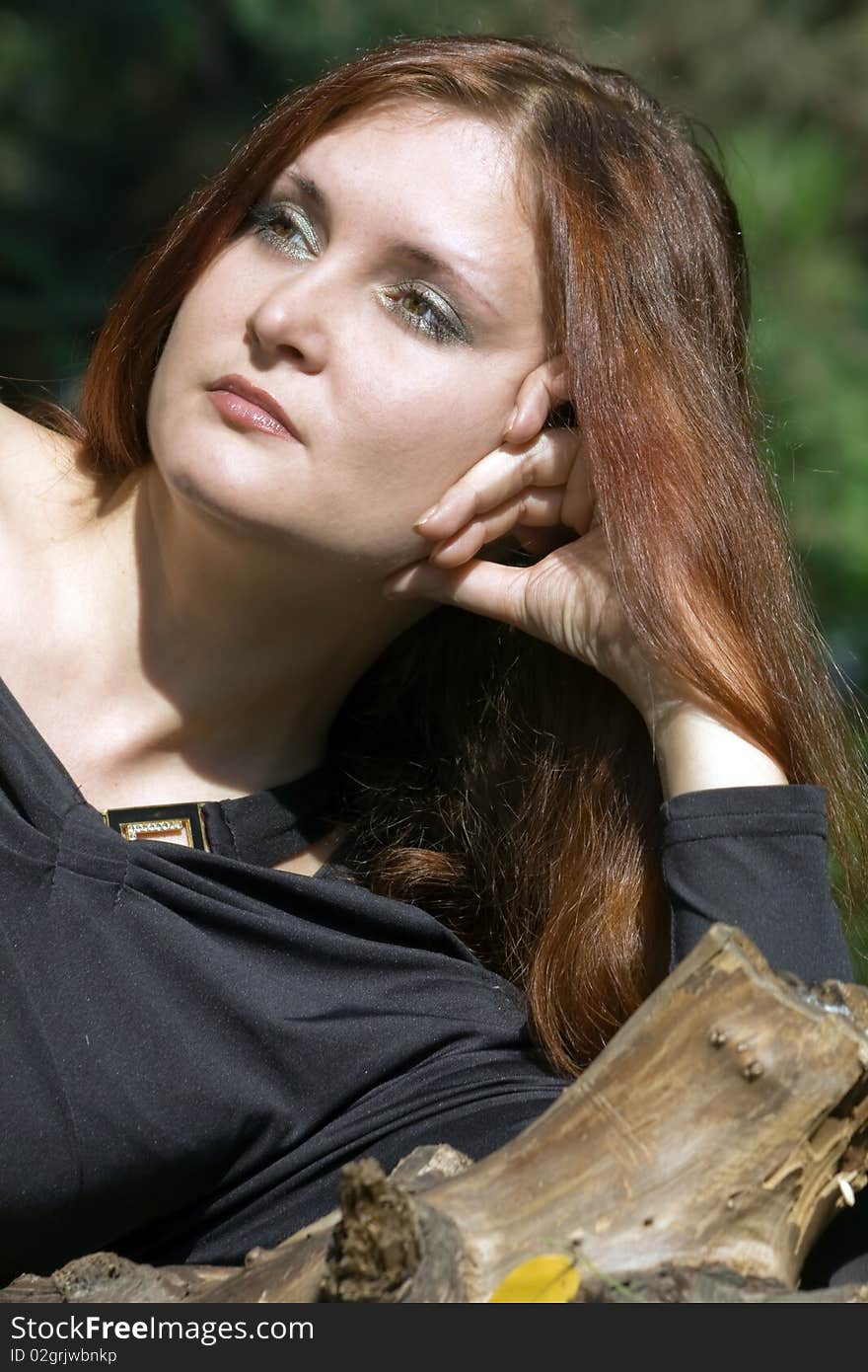 Beautiful young caucasian woman dreaming in the park. Beautiful young caucasian woman dreaming in the park