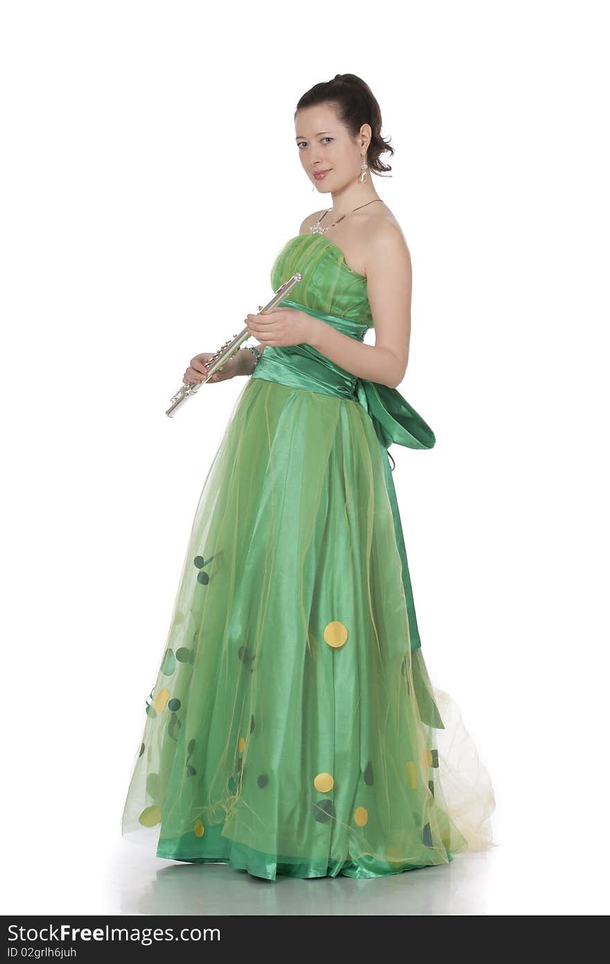 Attractive young female flautist, flutist holding flute. Evening green dress. Studio shot, white background.