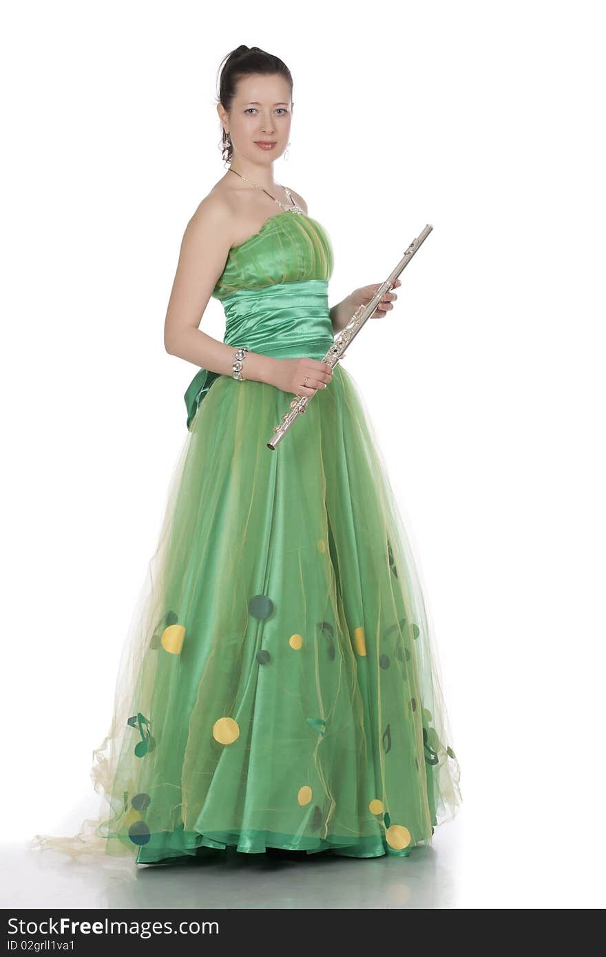 Attractive young female flautist, flutist holding flute. Evening green dress. Studio shot, white background.