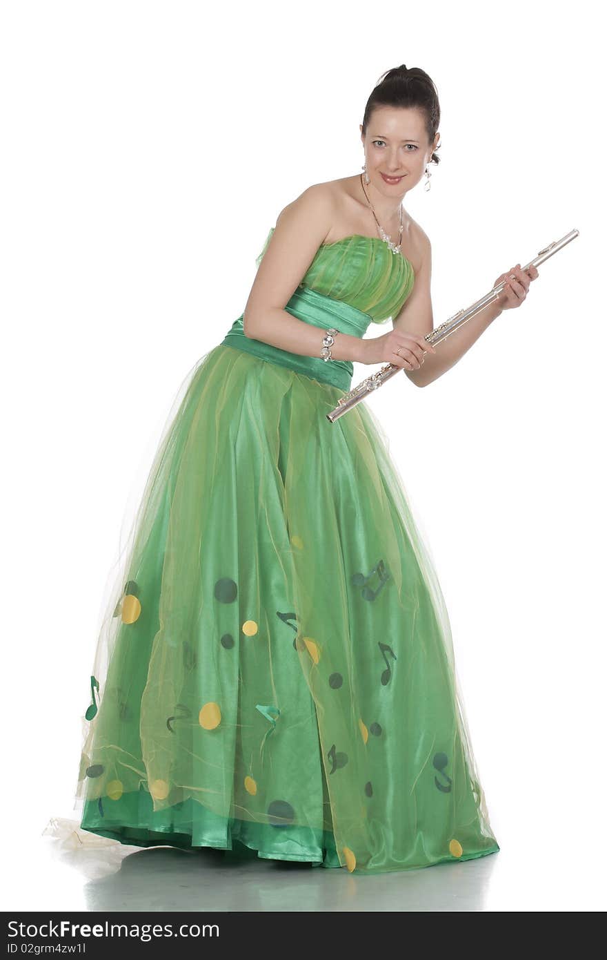 Attractive young female flautist, flutist holding flute. Evening green dress. Studio shot, white background.