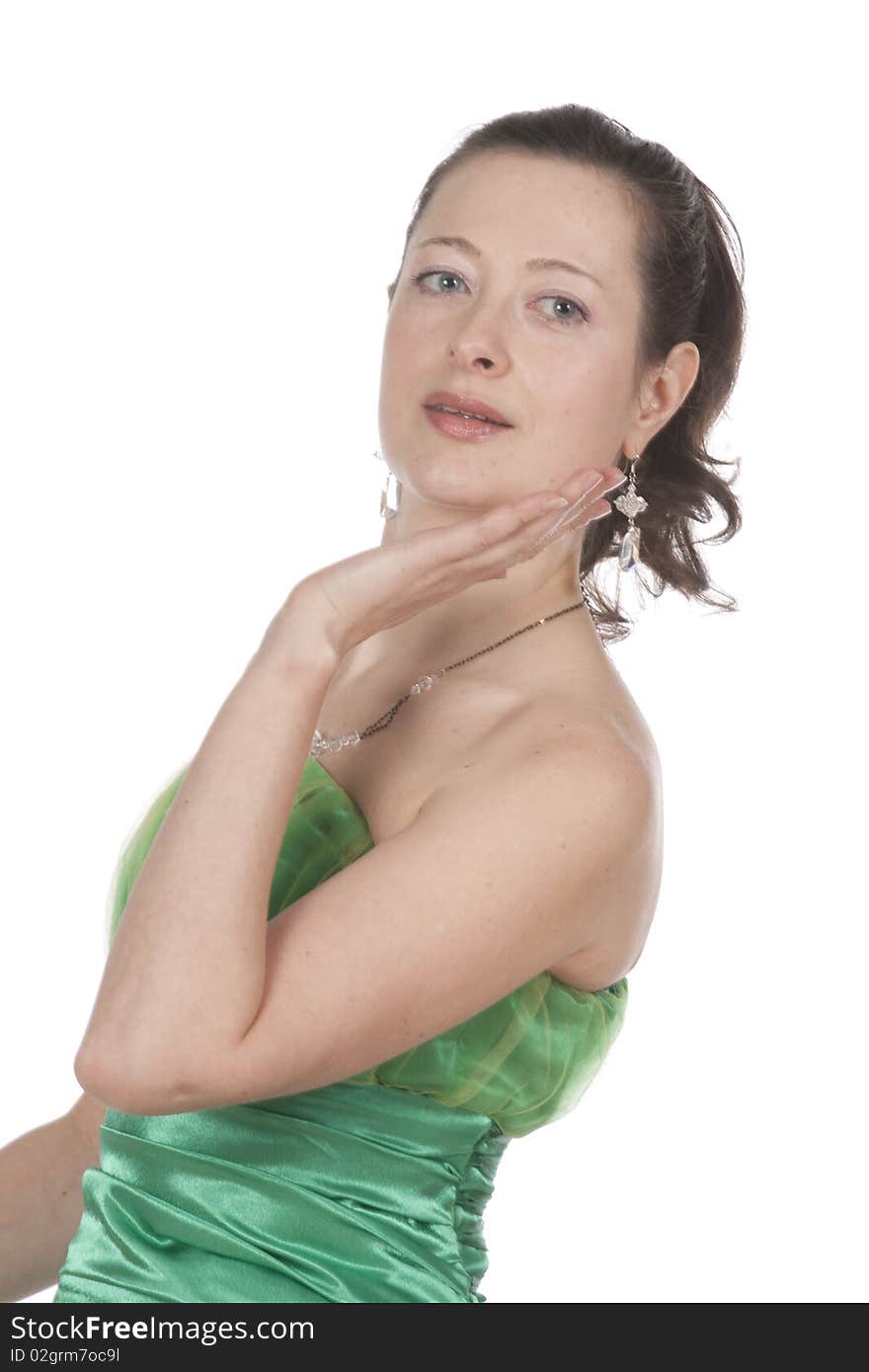 Attractive young female flautist, flutist holding flute. Evening green dress. Studio shot, white background.