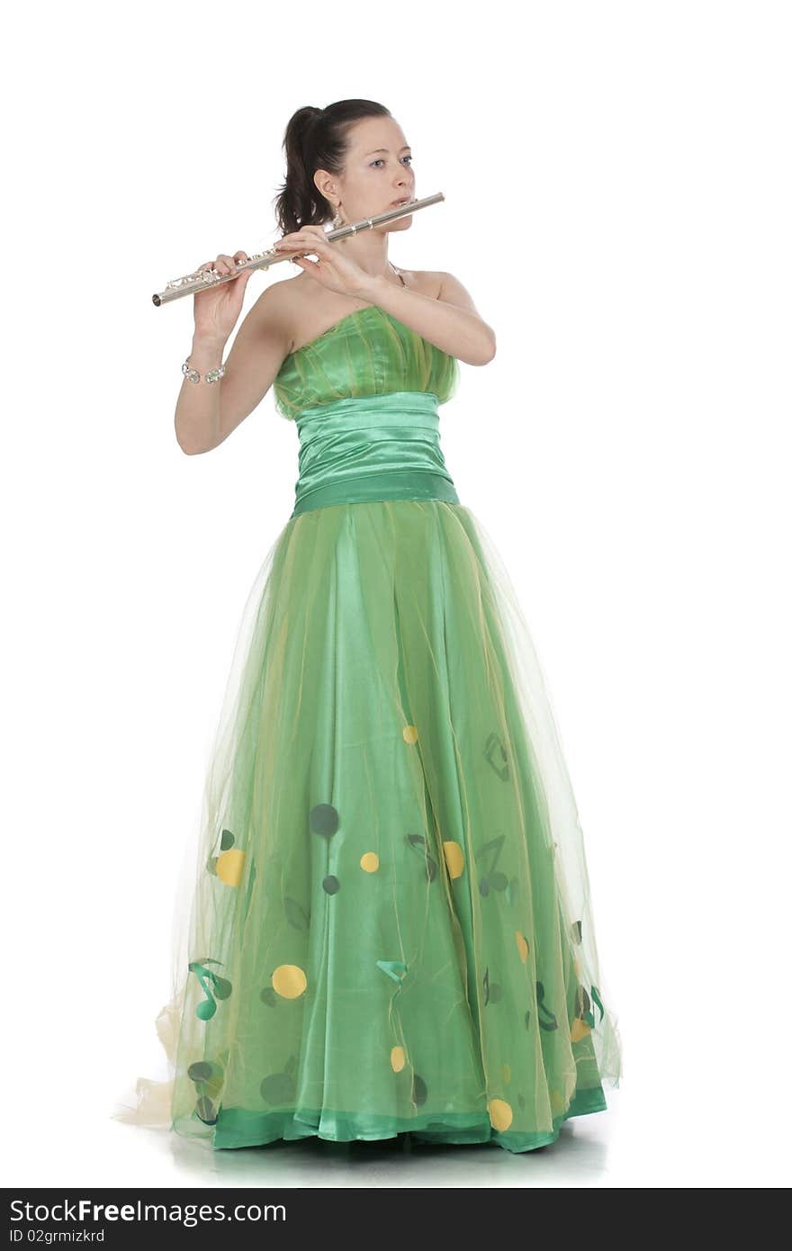 Attractive young female flautist, flutist holding flute. Evening green dress. Studio shot, white background.