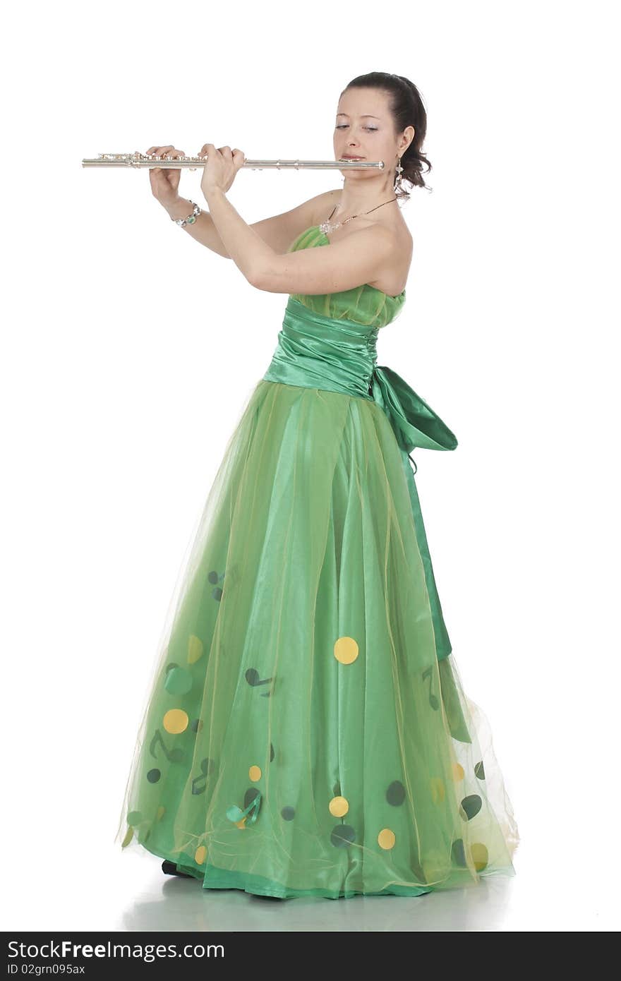 Attractive young female flautist, flutist holding flute. Evening green dress. Studio shot, white background.