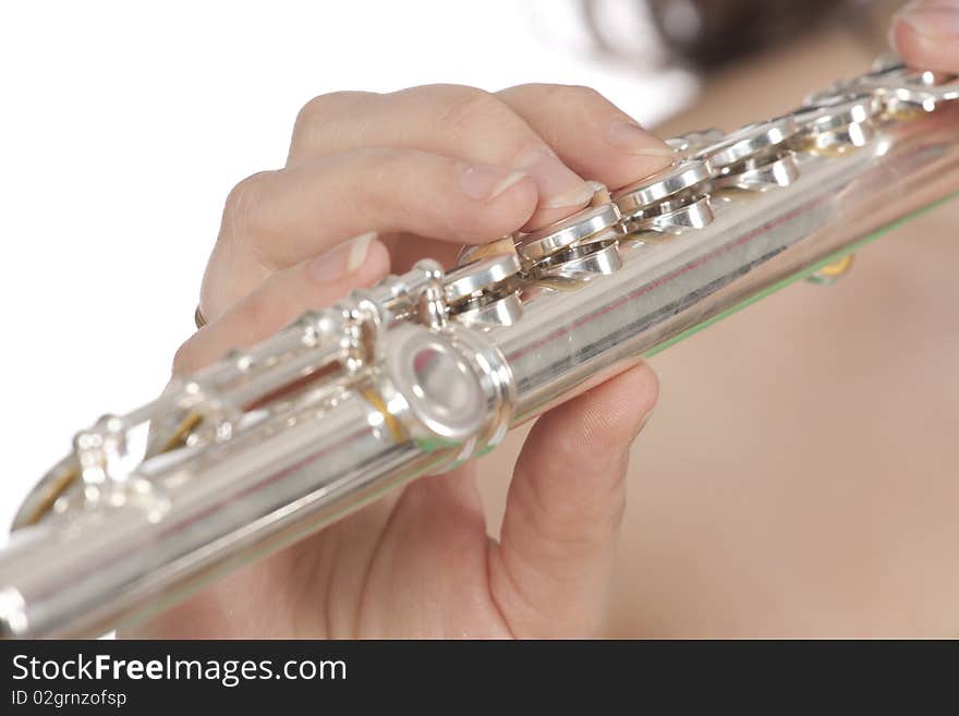 Attractive young female flautist, flutist holding flute. Studio shot, white background.