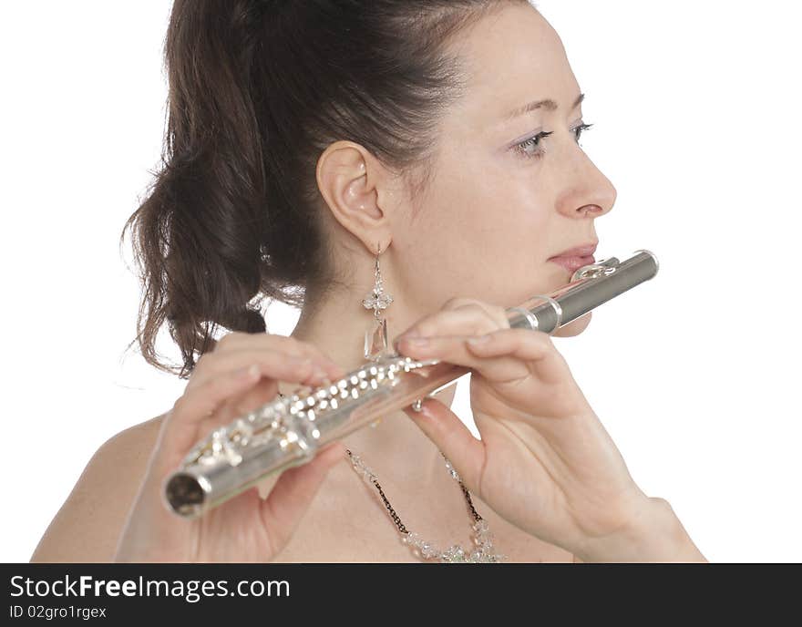 Attractive young female flautist, flutist holding flute. Evening green dress. Studio shot, white background.