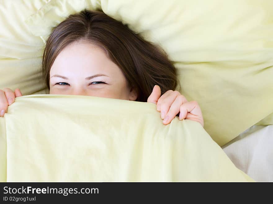 Young beautiful woman smiling in the bed. Young beautiful woman smiling in the bed