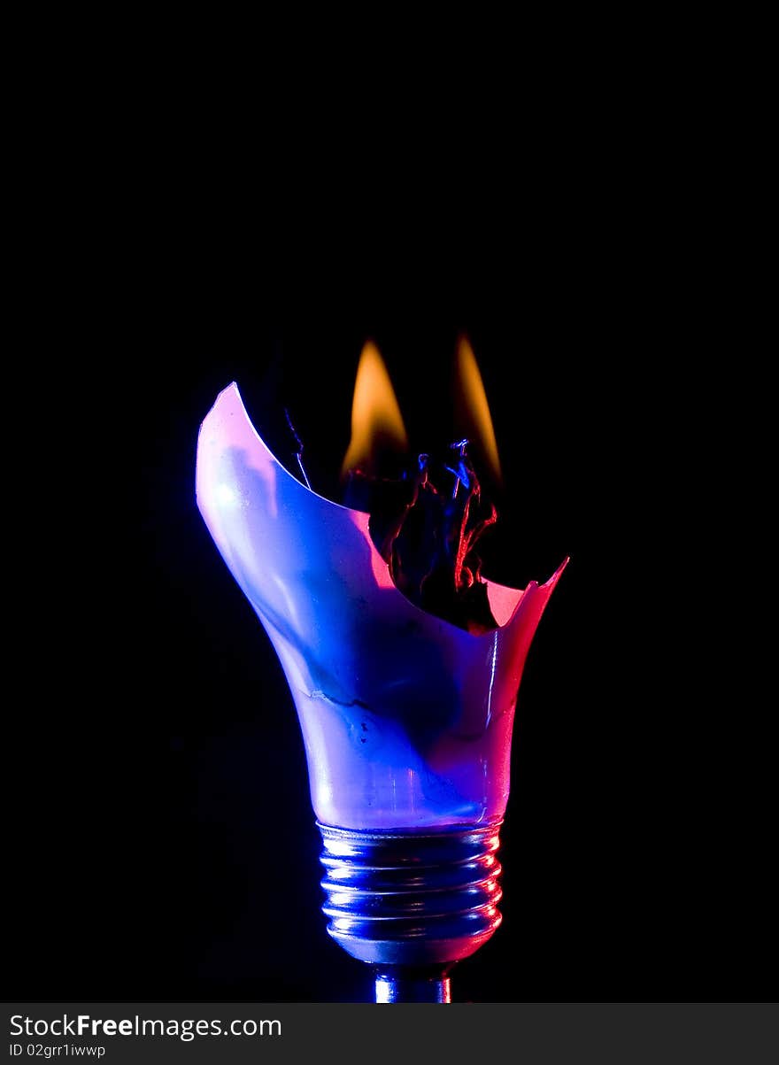 Broken light bulb with smoke on black background