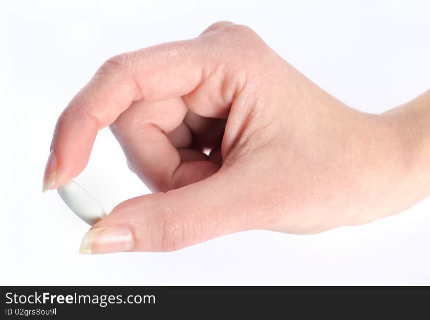 Isolated pill in woman hand