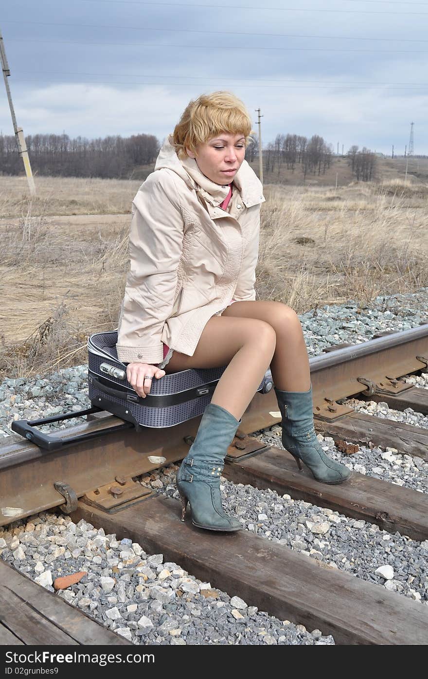 Woman on the bag on the rails