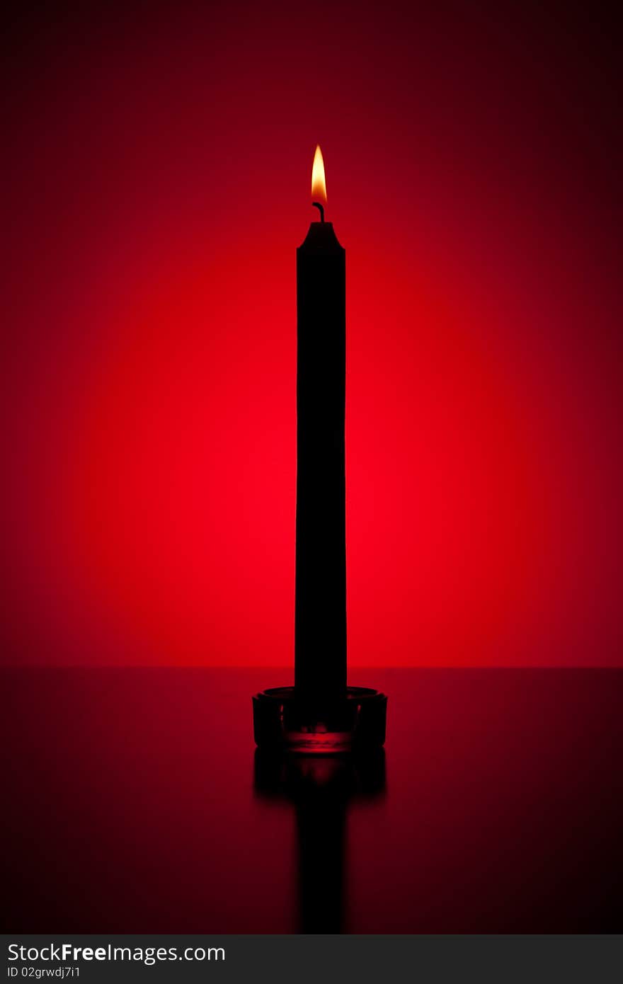 Candle in red lit backgrounded