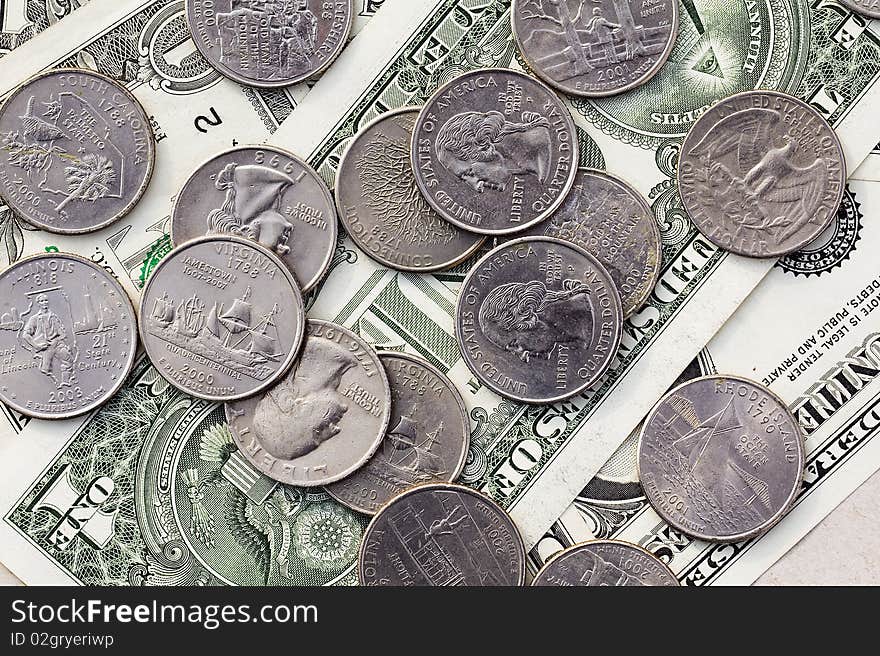 Coins in 25 cents scattered on dollars. Coins in 25 cents scattered on dollars