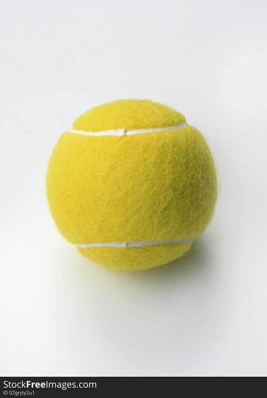 Yellow tennis ball on a white background