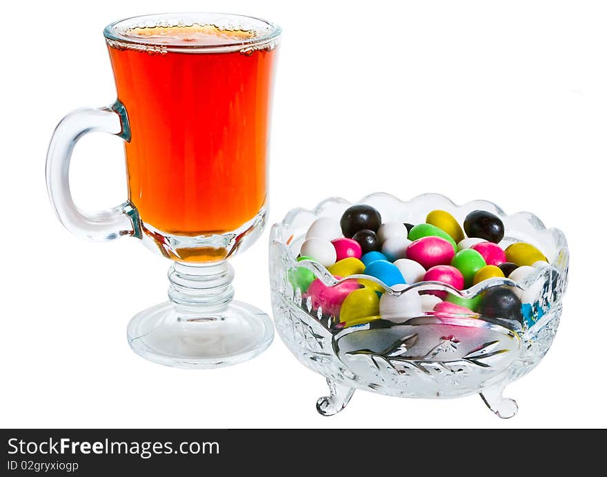 Vase with colour sweets and a tea glass