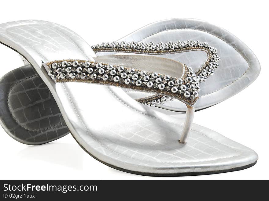 This is a beautiful ladies fancy silver shoes isolated on a white background. This is a beautiful ladies fancy silver shoes isolated on a white background.