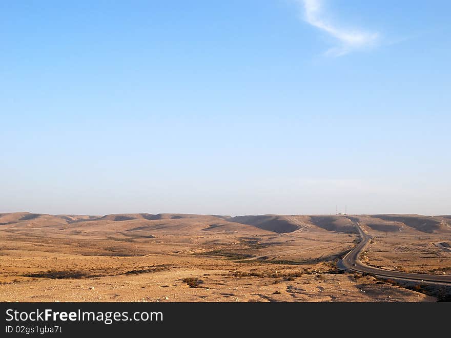 Fragment of Negev desert with mountains on a distance shot. Fragment of Negev desert with mountains on a distance shot