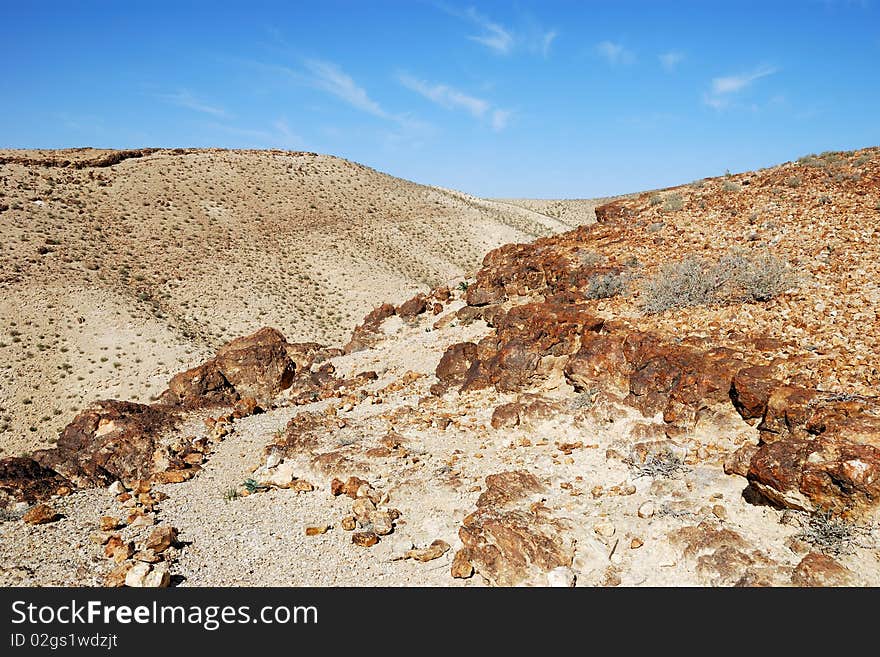 Ancient rocks under blue sky. Desert Negev, Israel. Ancient rocks under blue sky. Desert Negev, Israel.