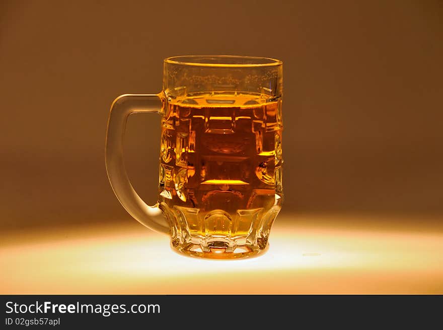 Beer mug filled with beer on one color background. Beer mug filled with beer on one color background