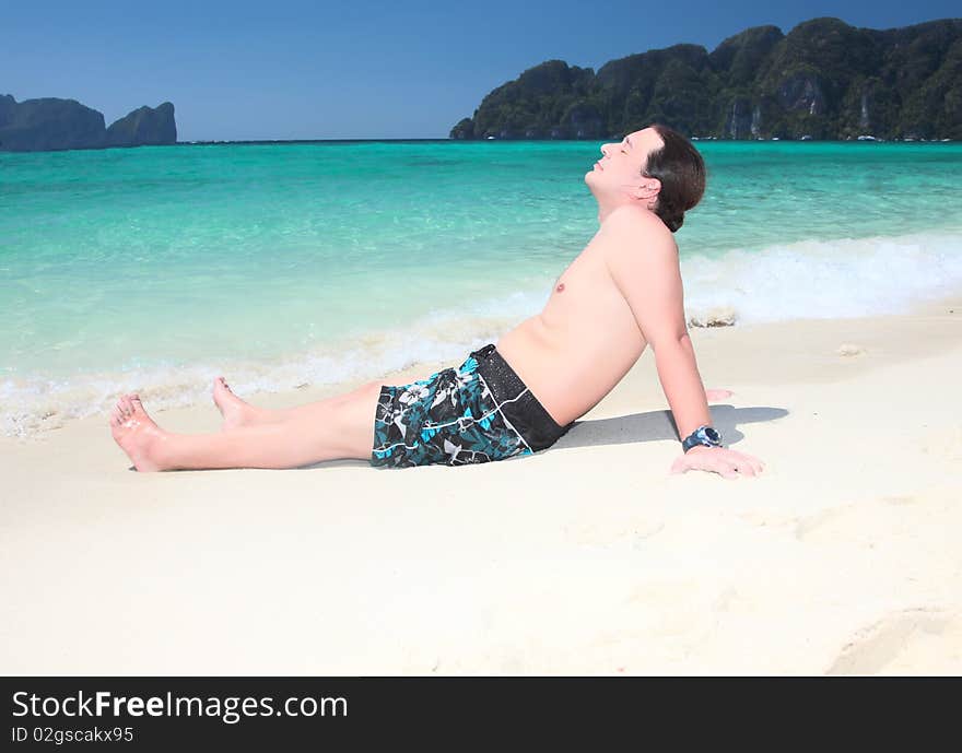 Young  boy relaxing on the beach. Young  boy relaxing on the beach.