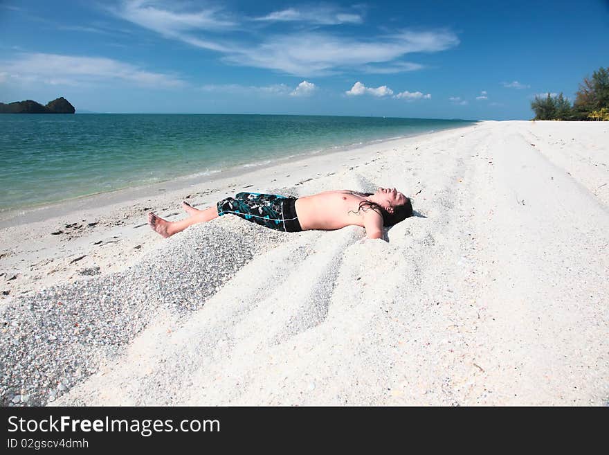 Young girl relaxing on the beach. Young girl relaxing on the beach.