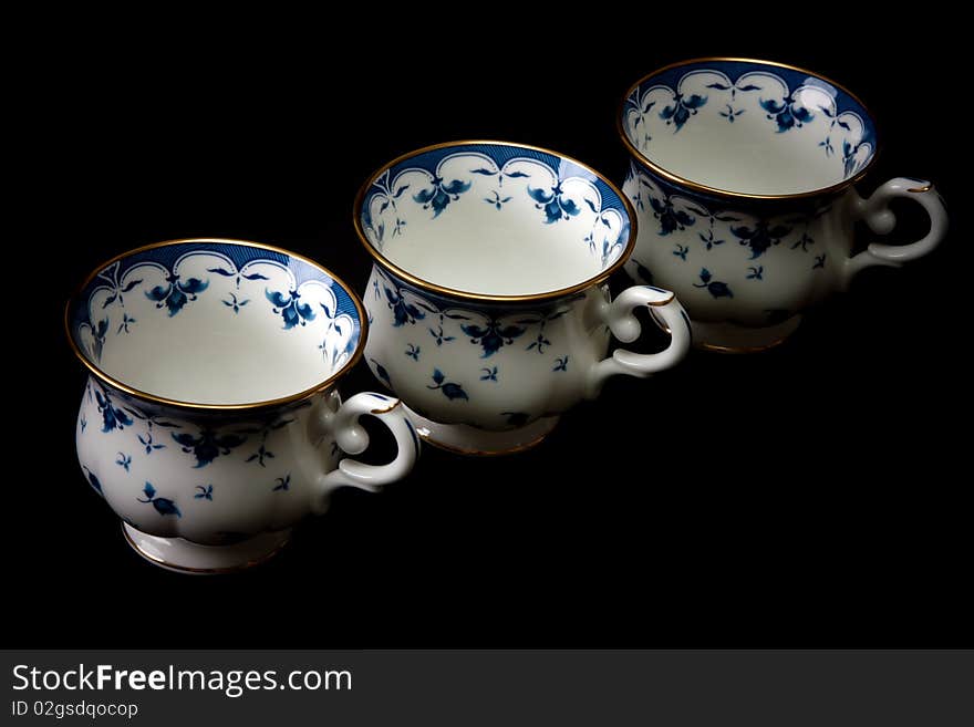 Three tea cups on saucer insulated on white background