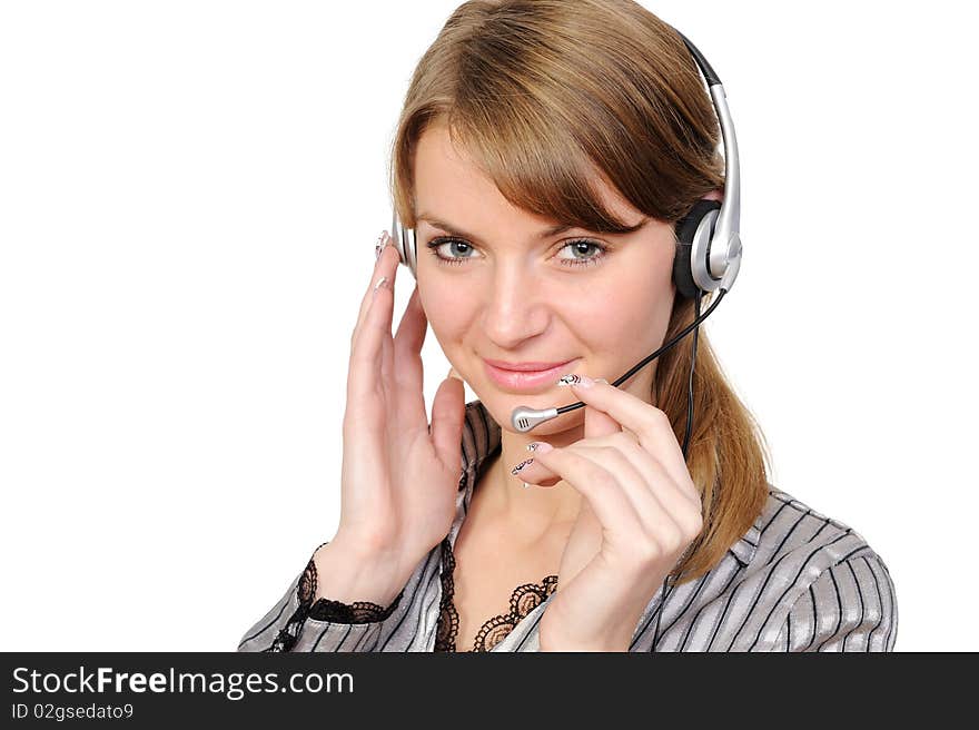 Beautiful young woman in headphones smiles in current of telephone conversation on a white background. Beautiful young woman in headphones smiles in current of telephone conversation on a white background