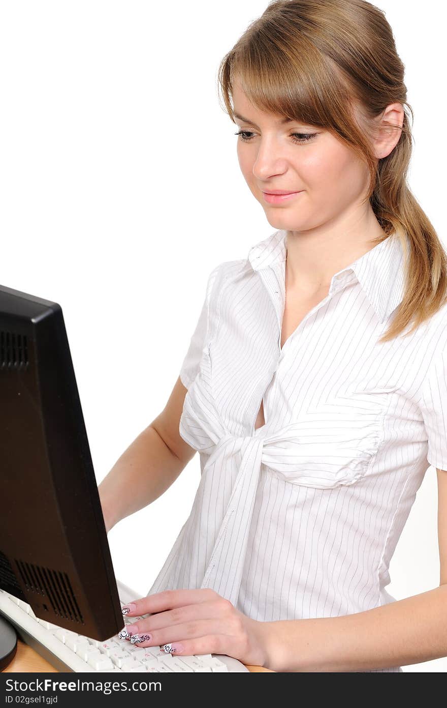 Business woman portrait smiling in front of her desktop computer. Side View. Business woman portrait smiling in front of her desktop computer. Side View