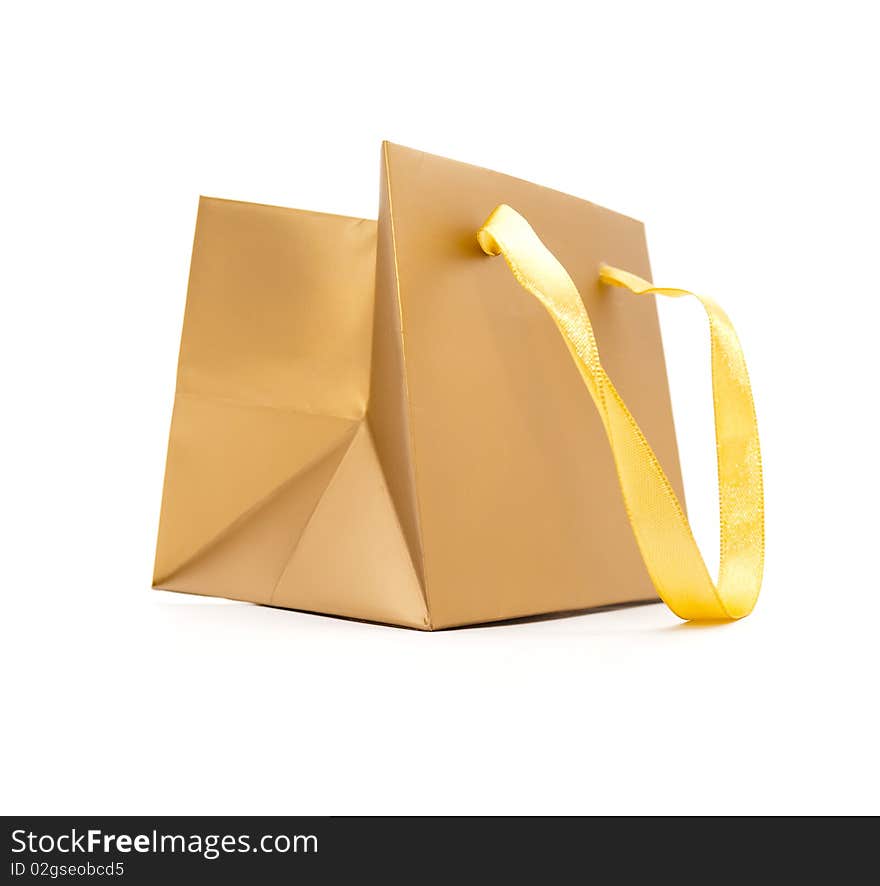 Gift package of gold colour on a white background