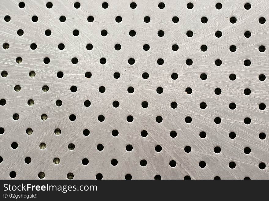 A metal background with holes. A metal background with holes