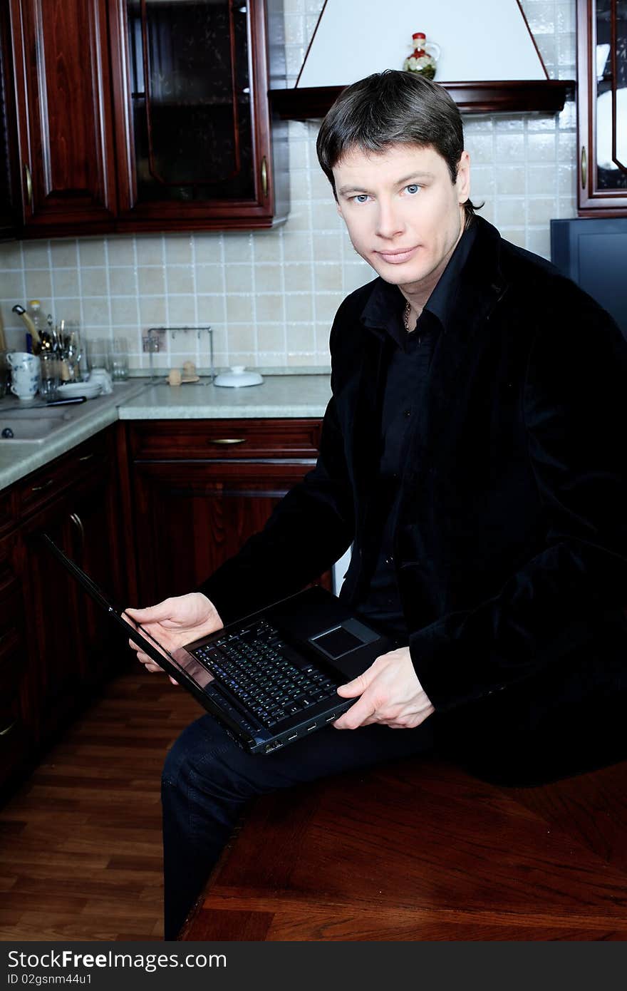 Handsome stylish man at home with a laptop. Handsome stylish man at home with a laptop