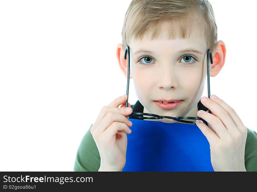 Portrait of a boy in a funny glasses holding a book. Isolated over white background. Portrait of a boy in a funny glasses holding a book. Isolated over white background.