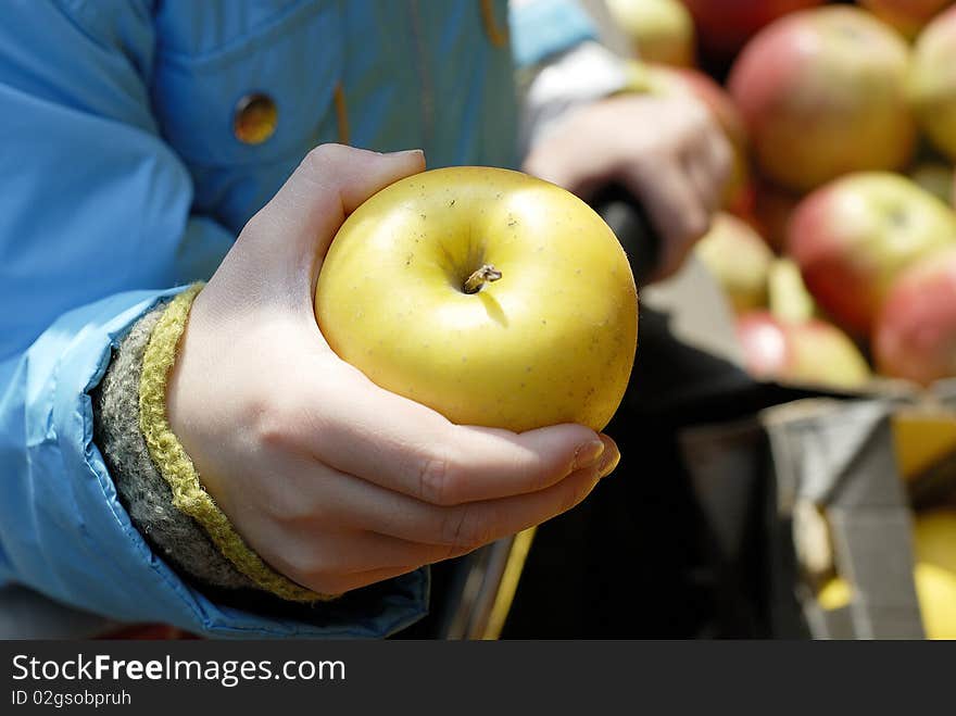 Green Apple in child's arm