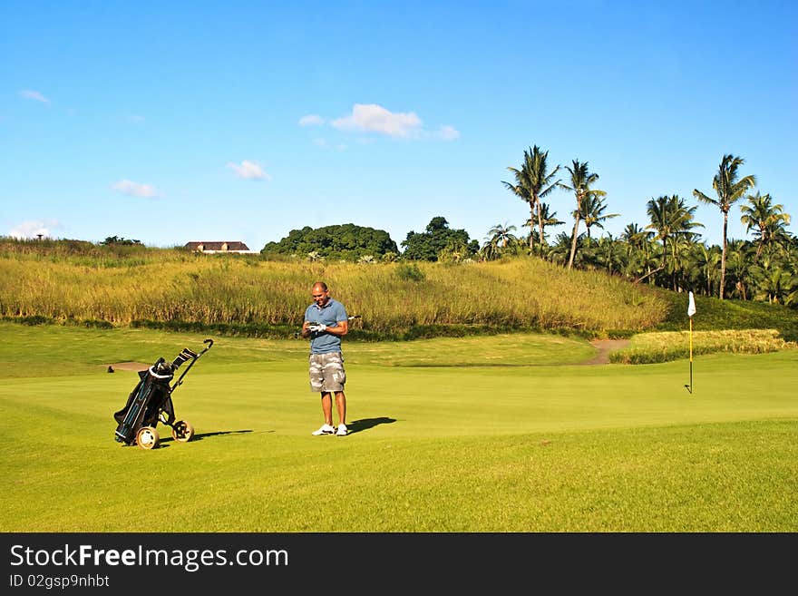 Happy golfer writing on scorecard after a tournament round.