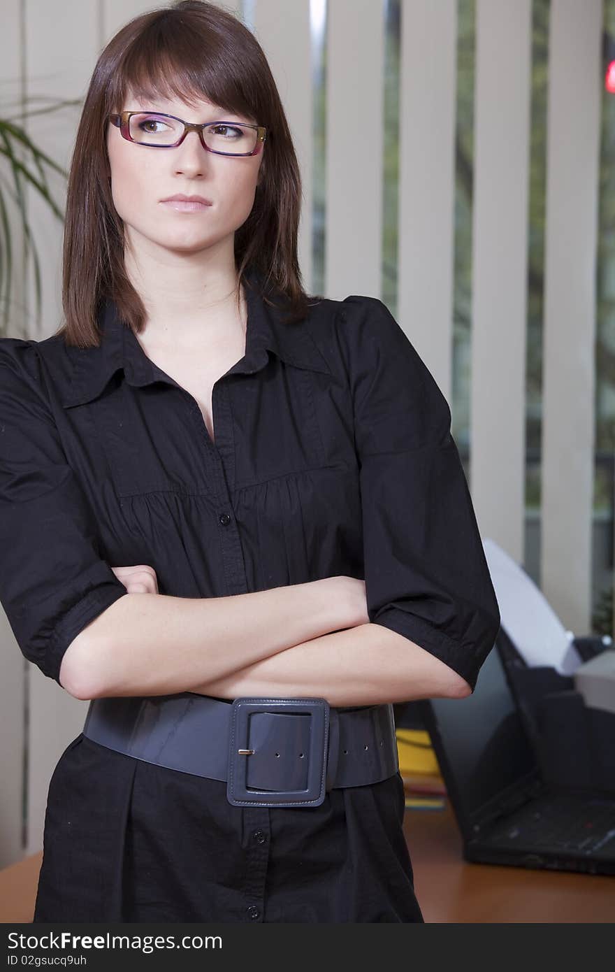 Thinking business woman standing in the office. Thinking business woman standing in the office