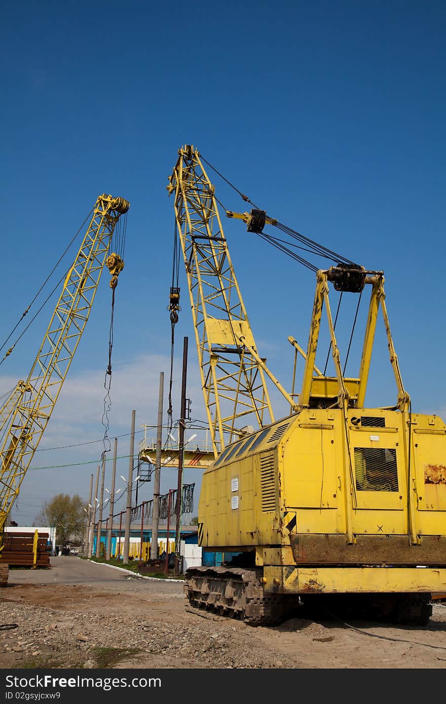 Yellow cranes at an industrial site in Romania.