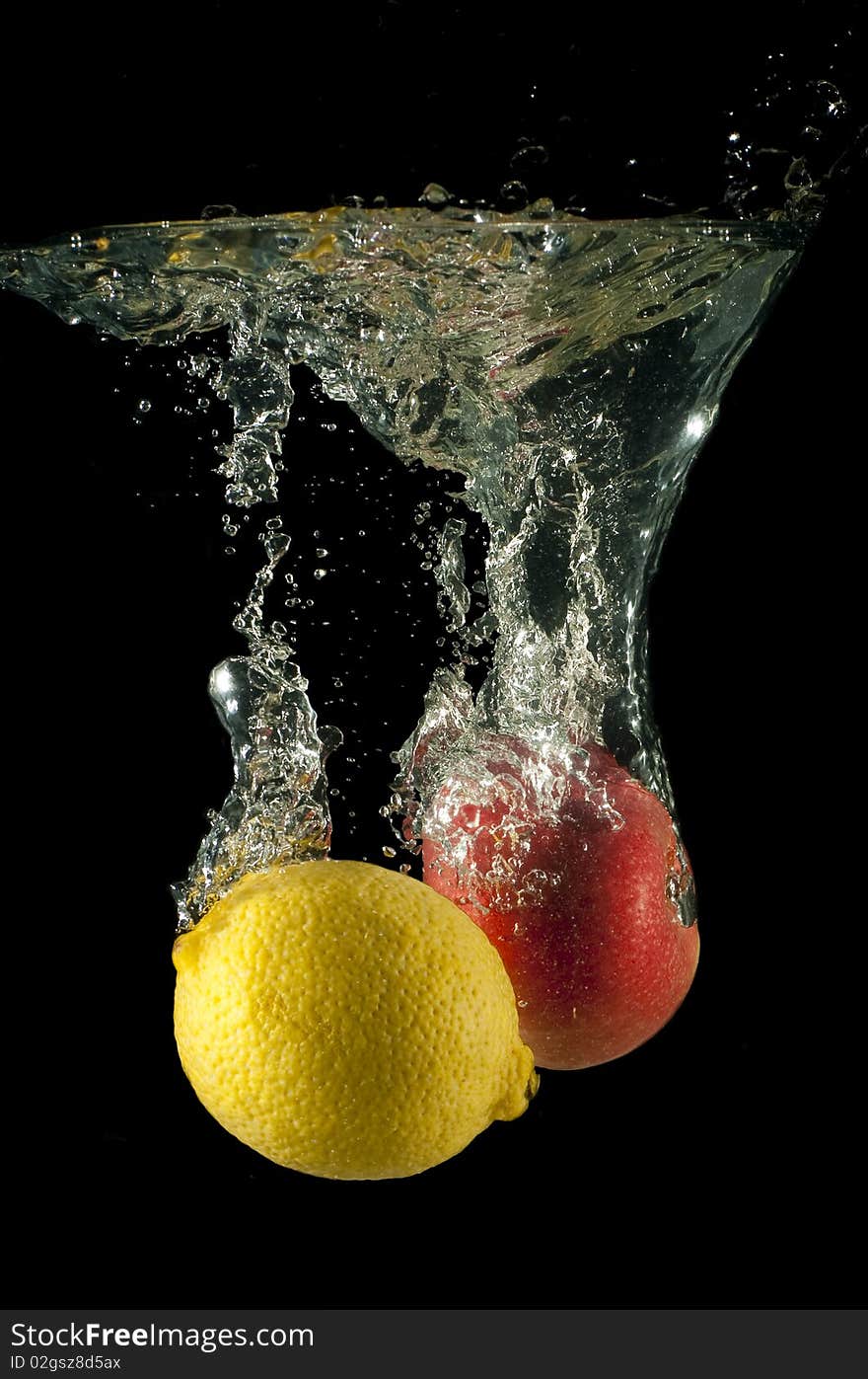 Lemon and apple fall in water