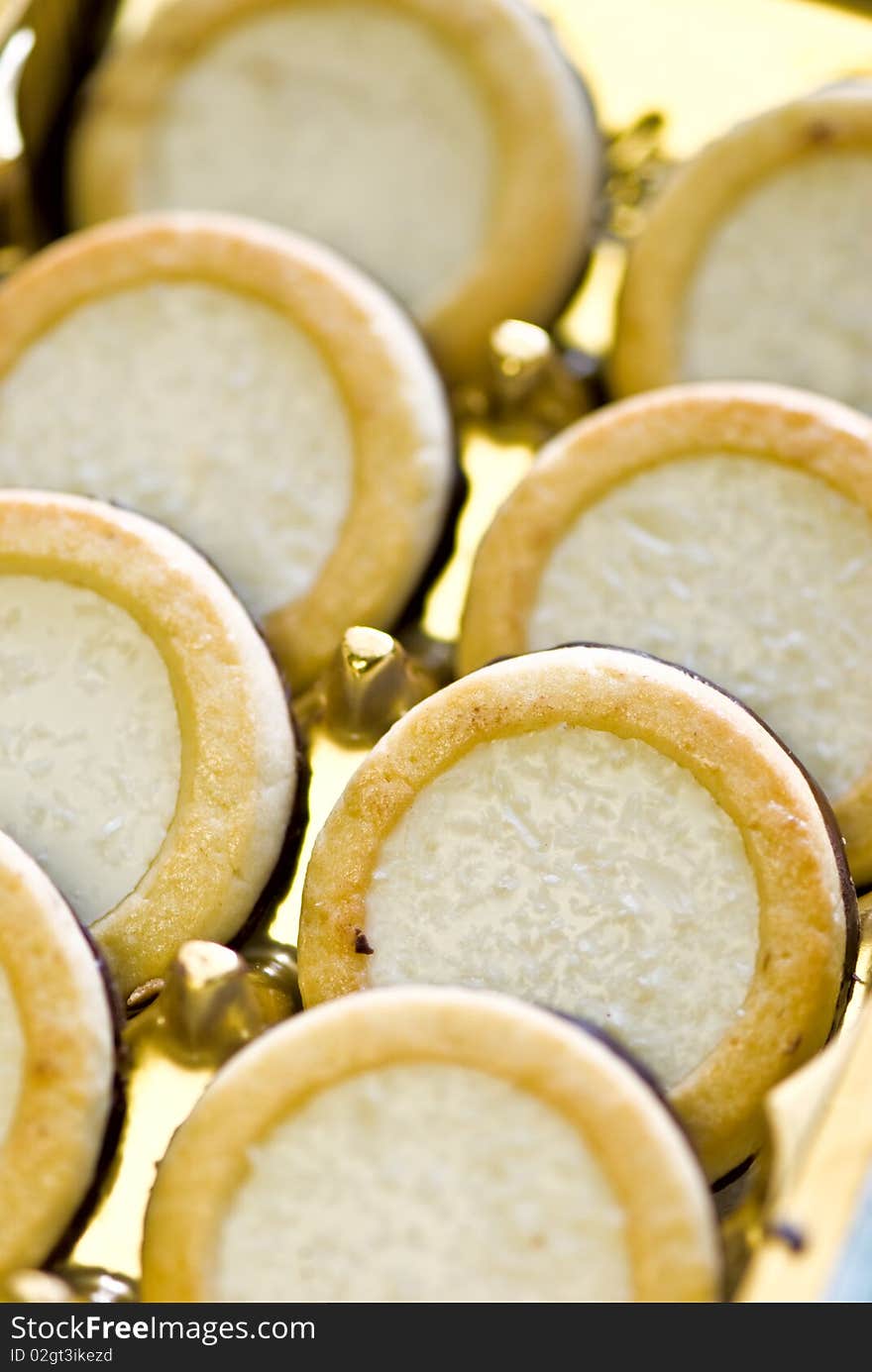 Coconut cookies decorated with a coconut shaving and the chocolate, laid out abreast