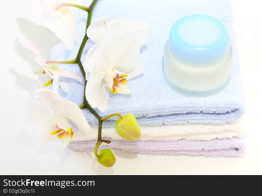 Tender orchids, creme and towels on the table