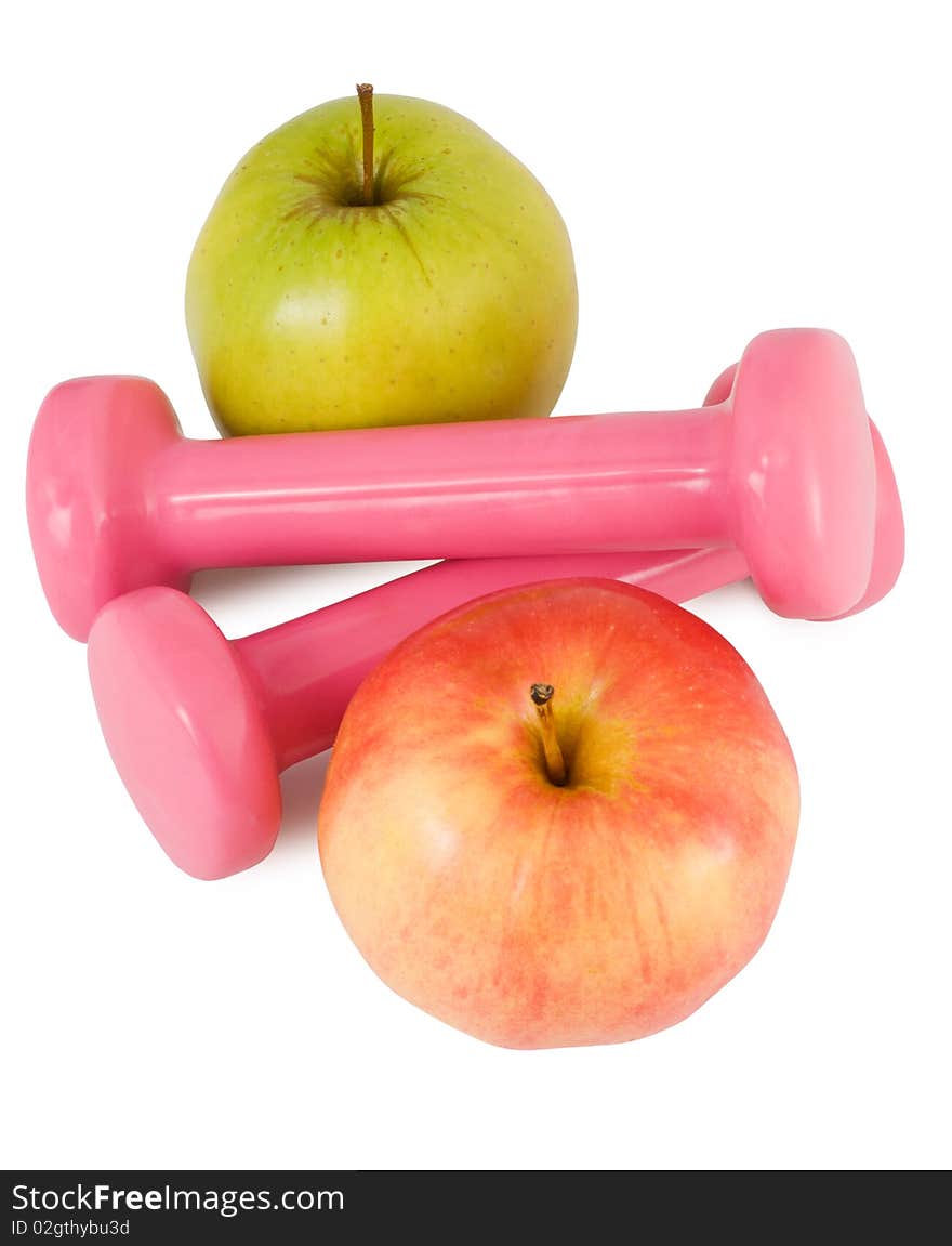 Two pink dumbbells and two apples on a white background. Two pink dumbbells and two apples on a white background