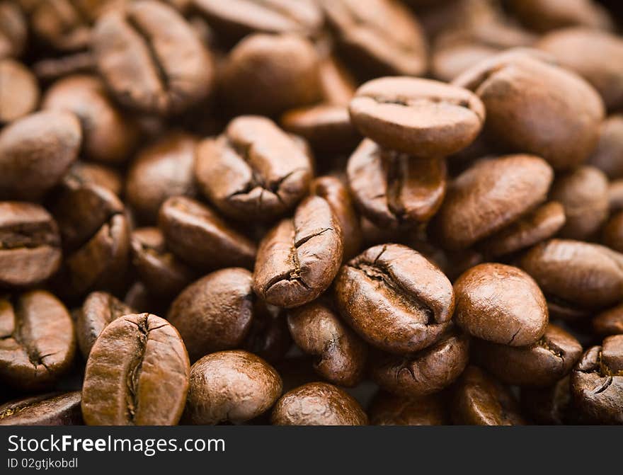 Rich brown coffee beans in pile. Rich brown coffee beans in pile