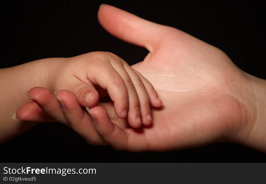 Hands of son and mother. loving touch