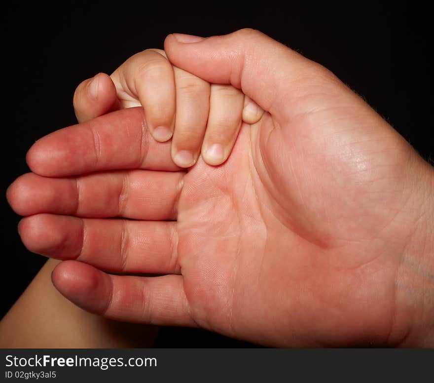 Hands of son and father. loving touch