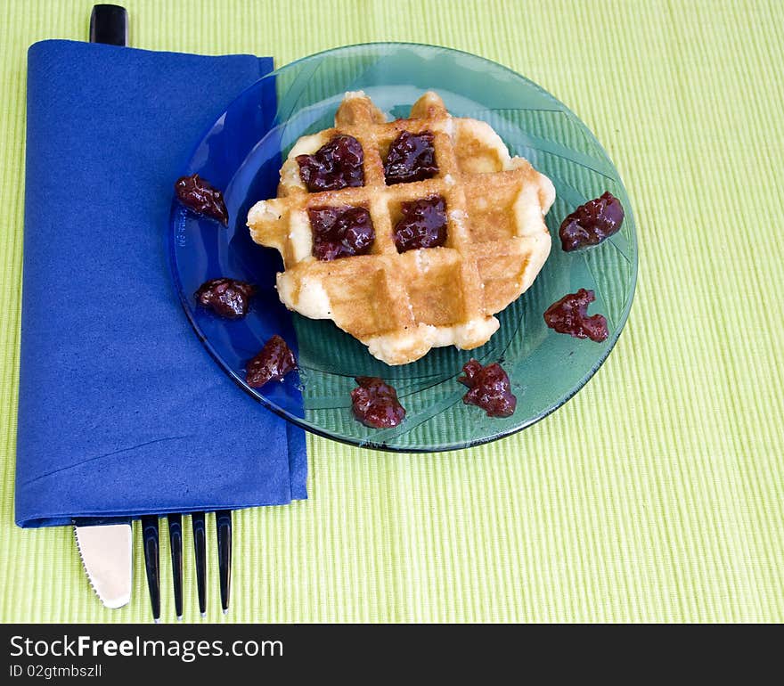 Cherry jam on a hot waffle, freshly made. Cherry jam on a hot waffle, freshly made